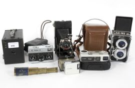 An assortment of vintage cameras, including a Kodak 'Brownie' 120,