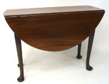 A George III mahogany oval drop leaf dining table, on tapered supports with pad feet,