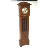 An early to mid-20th century oak and glazed longcase clock, fan-shaped relief details,