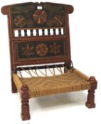 A carved and painted low tribal chair, the spindle back carved with panels of parrots and medalions,