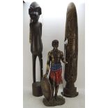 Two carved wooden African tribal sculptures and a similar resin example,