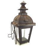 A hanging metal garden lantern, of pagoda form with glazed doors, suspended from chains and hook,