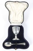 A silver Christening set in fitted box, comprising an eggcup and spoon,