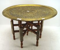 A Middle Eastern brass topped table,