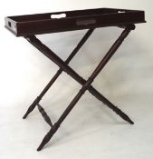 A mahogany butlers tray on folding stand,