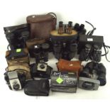 A collection of vintage cameras and binoculars, including a pair of Prinz 8x40, Miranda 16 x 50,