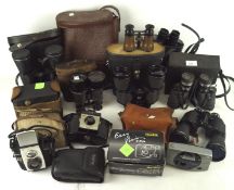 A collection of vintage cameras and binoculars, including a pair of Prinz 8x40, Miranda 16 x 50,
