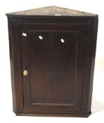 A 20th century wooden games corner cabinet, the panelled door opening to reveal three shelves,