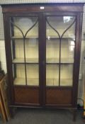 An Edwardian mahogany glazed display cabinet, opening to reveal four shelves,