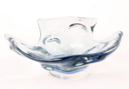 A contemporary glass dish of abstract form, coloured in alternating shades of blue and green,