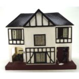 A vintage mock Tudor style doll's house, mid-century, including some fittings and contents,