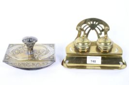 An Art Noveau brass inkwell with a blotter, each cast with scrolls,