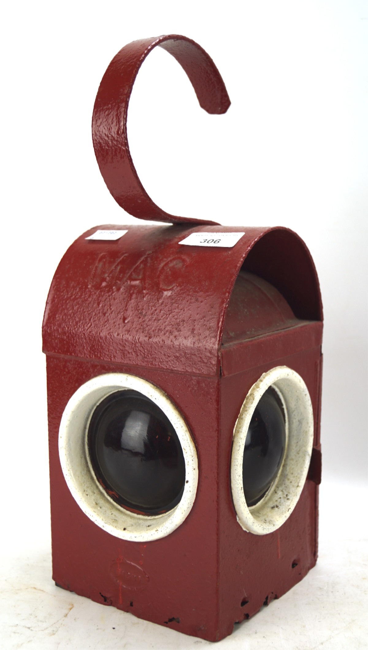 A vintage mid-century Mac hand held lantern, painted in red and white, with three red lights,