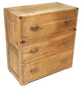 A contemporary oak campaign-style chest of drawers, with three drawers and chromed fittings,