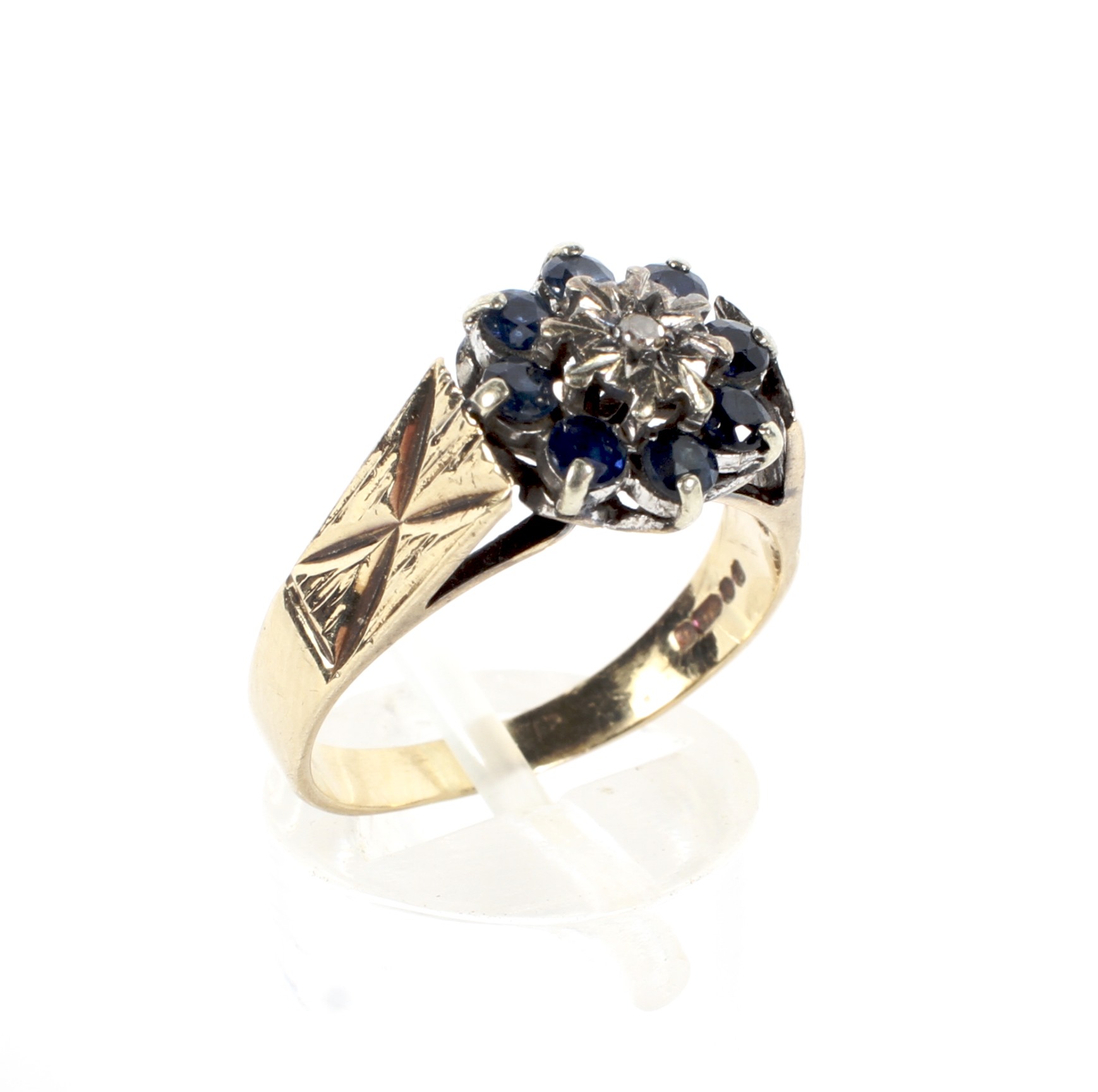 A mid 20th century 9ct cluster ring, set with a central diamond surrounded by sapphires,