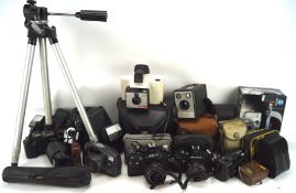 Large collection of vintage cameras and related equipment, including: a Canon T70, a Pentax MG,