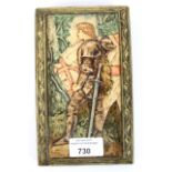 A 20th century painted pottery wall plaque moulded in low relief with a knight and horse,