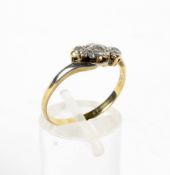 A yellow metal three stone diamond ring, set in a twist mount, indistinct hallmark, size P,