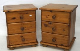 A pair of modern pine bedside cabinets