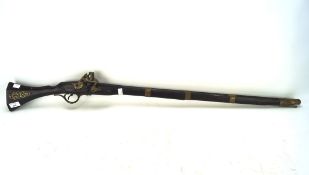 A replica gun, with engraved gilt-metal mounts and stained stock,