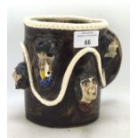 An Alan Young (Devon) studio pottery mug with moulded with bearded men and pirates,