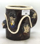 An Alan Young (Devon) studio pottery mug with moulded with bearded men and pirates,