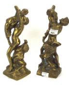 A pair of cast metal sculptures, each depicting classical figures,