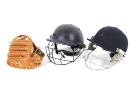 Two cricket helmets and a baseball glove, one of the helmets being by Masuri,