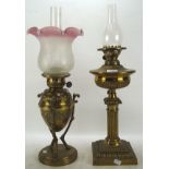 Two Victorian oil lamps, both with brass frames and reservoirs,