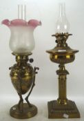 Two Victorian oil lamps, both with brass frames and reservoirs,