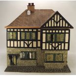 A vintage doll's house, in the Tudor style, with some contemporary and later fittings and contents,