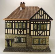 A vintage doll's house, in the Tudor style, with some contemporary and later fittings and contents,