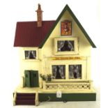 A vintage doll's house, with later signs for the Snooty Fox Pub,