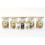 A set of seven Crown Devon Retro named kitchen storage jars, including Tea, Coffee,