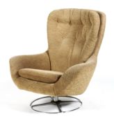 A Mid 20th century upholstered swivel armchair, on a chrome circular metal base,