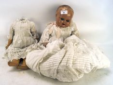 Two early 20th century dolls, one missing the head, each with composition head/bodies,