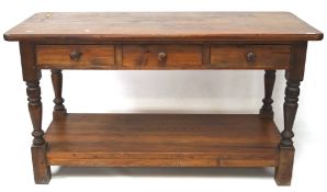 An early 20th century stained pine large two tier buffet with three drawers on turned and block