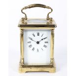 A brass carriage clock, the enamelled dial with Roman numerals denoting hours, H11.