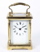 A brass carriage clock, the enamelled dial with Roman numerals denoting hours, H11.