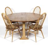 An Ercol blonde elm and beech wood drop leaf dining table and a set of four hooped spindle back