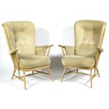 A pair of Ercol beech and elm high spindleback armchairs with removable cushions,