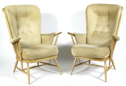 A pair of Ercol beech and elm high spindleback armchairs with removable cushions,