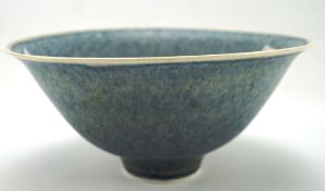 A Studio porcelain flared bowl, impressed shield to base, enriched in speckled blue glazes,