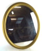 A vintage 1970s gilt framed wall mirror, of oval form,