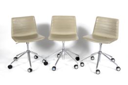 A set of three Andreu World (National Design Award Company 2007) faux leather swivel chairs raised