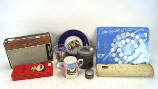 An assortment of mixed collectables including badges, a Philips Radio,