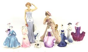 A collection of ceramic figures of ladies,