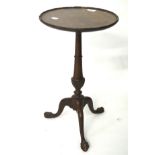 A mahogany wine table, raised on a tripod base with ball and claw feet,