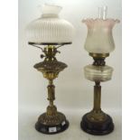 Two late 19th and early 20th century oil lamps, with glass, ceramic and brass reserves,