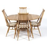 An Ercol dining room suite comprising a drop leaf table and four high spindle back dining chairs,